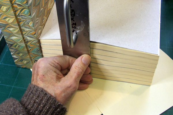 Squaring-up a pile of sheets before padding them