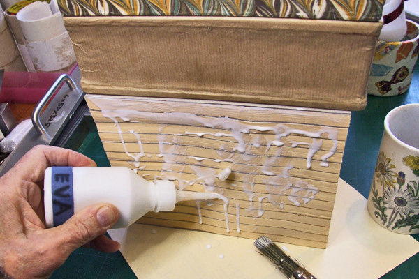 Applying EVA by glue pot with a spout, prior to brushing