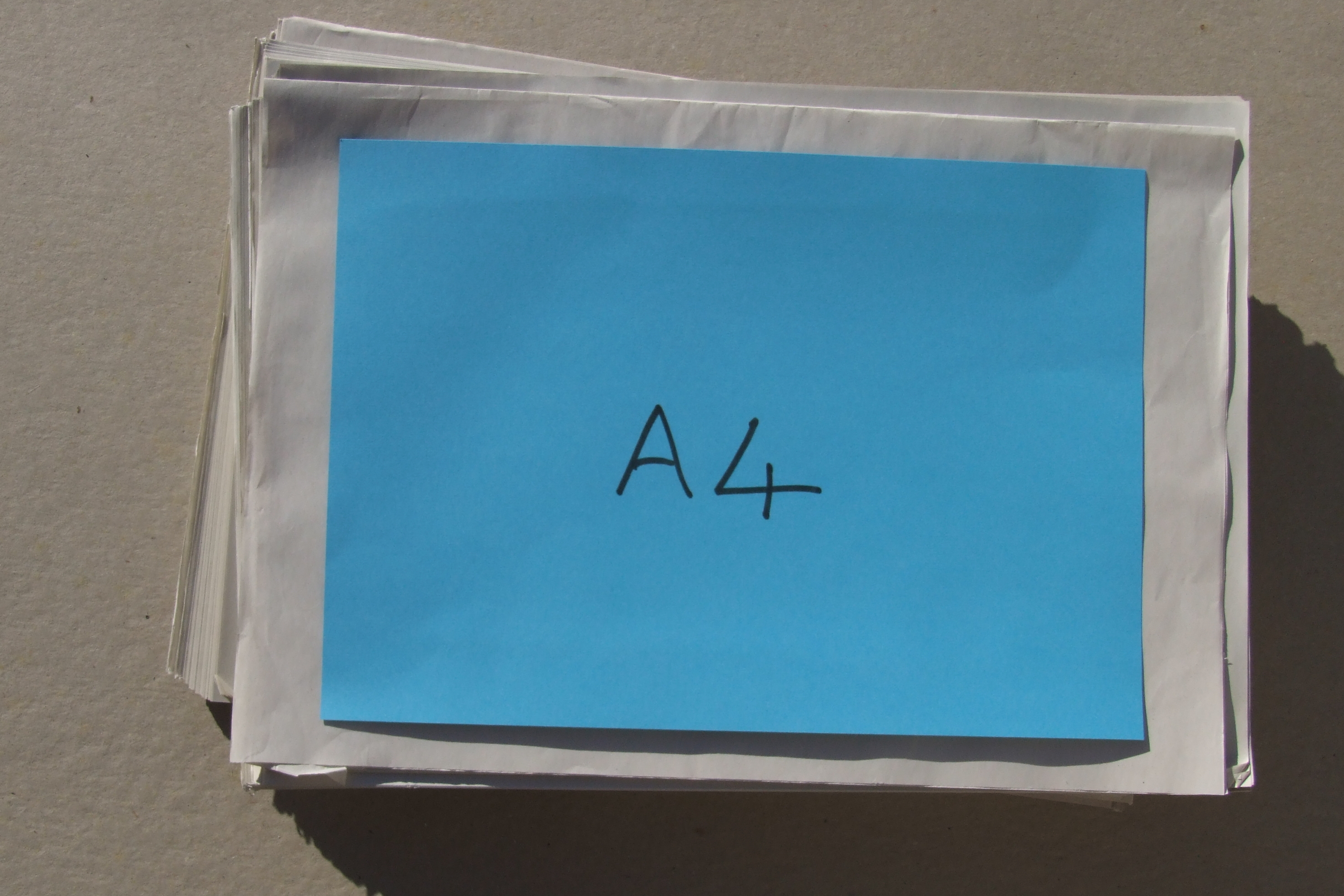 Half a sheet of newsprint with an A4 sheet to give scale