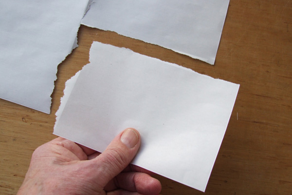 Finding the direction of grain in a sheet of paper