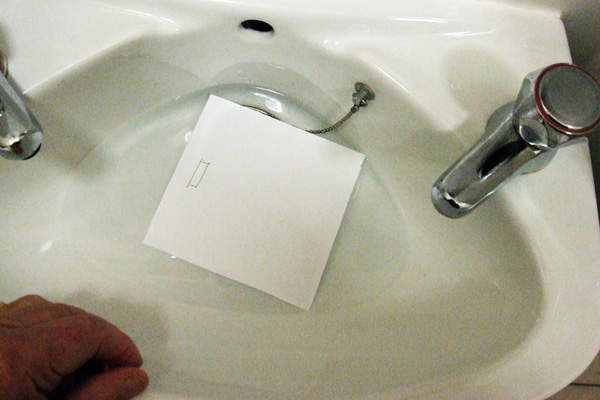 Testing paper with water to find the grain