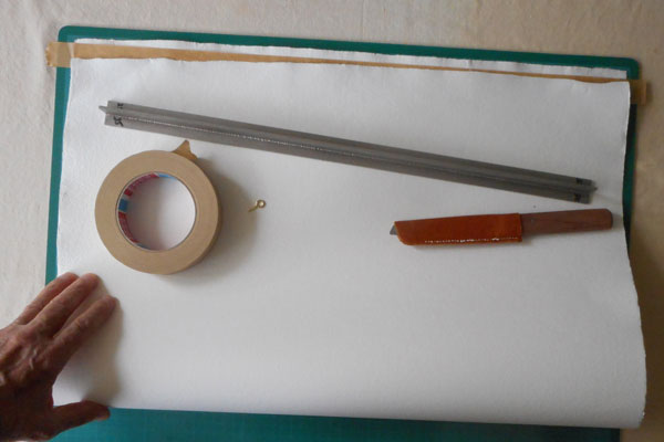 Folding a sheet of handmade paper which is out of square