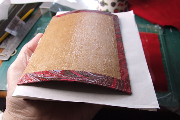 Curled cover during end-paper pastedown