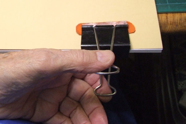 First clip secures the loose sheets