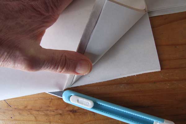Slicing a bundle of papers with a sharp knife